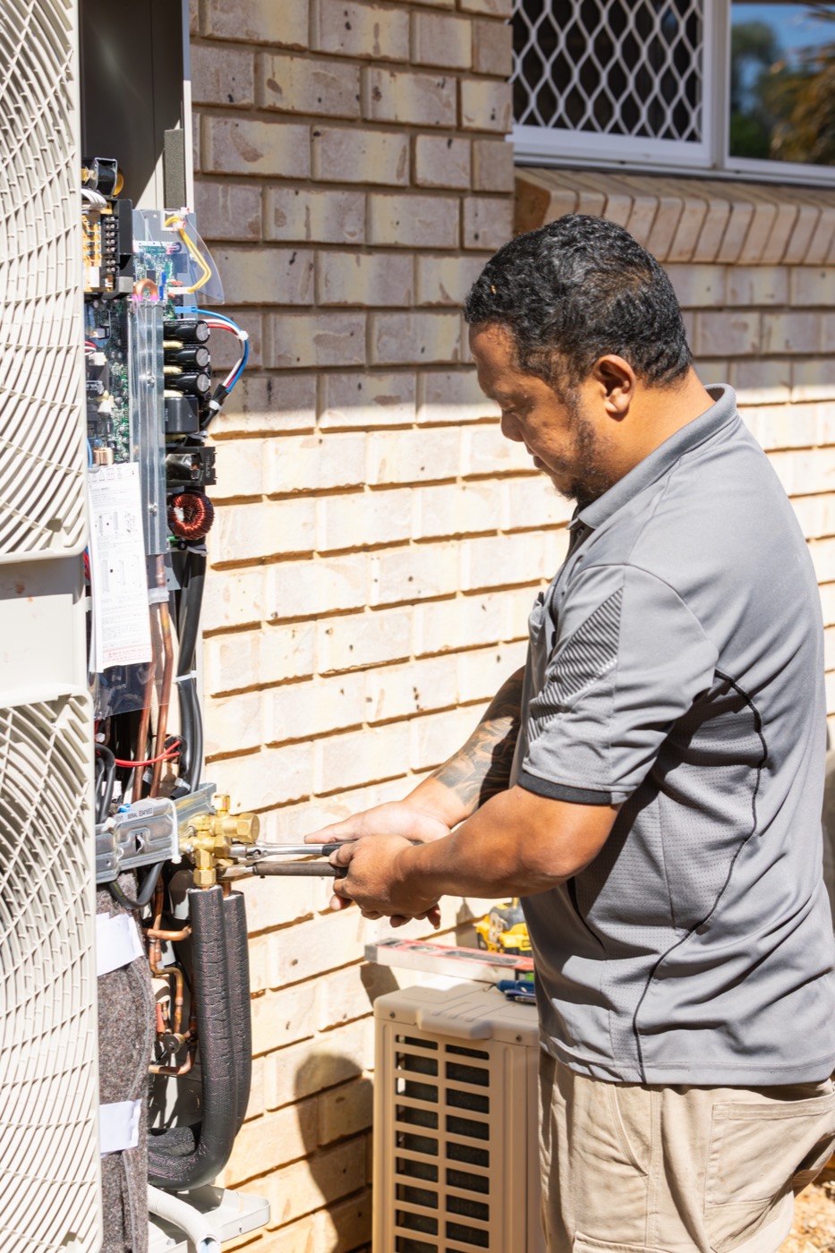 Technician fault-finding on an air conditioning unit