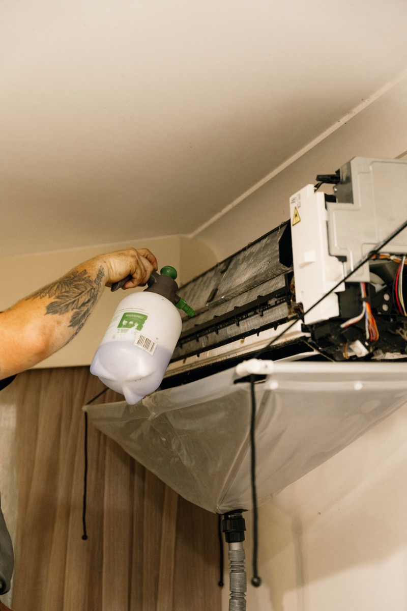 Technician servicing a wall-mounted split system